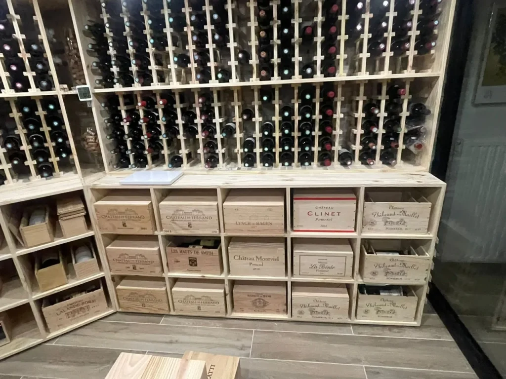 Mur de casiers individuels et caissons à caisses bois dans une cave à vin sur mesure en Alsace